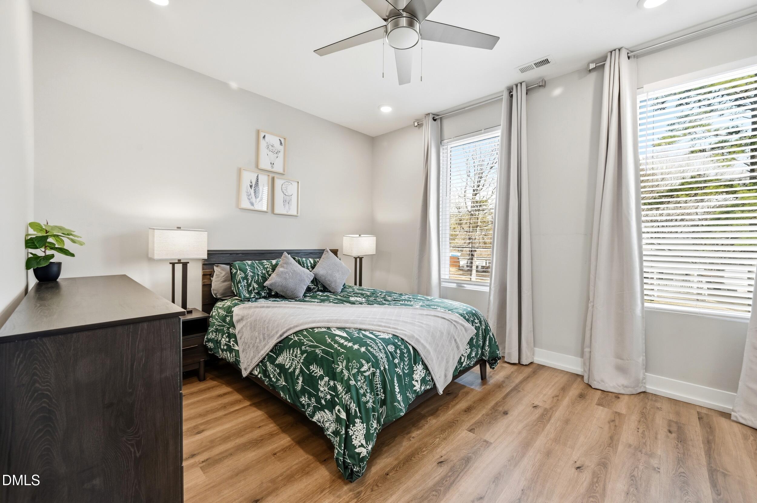 3138 Rowena Avenue Durham, NC 27703 - Photo 22 of 31 a bedroom with a large bed chandelier and a window