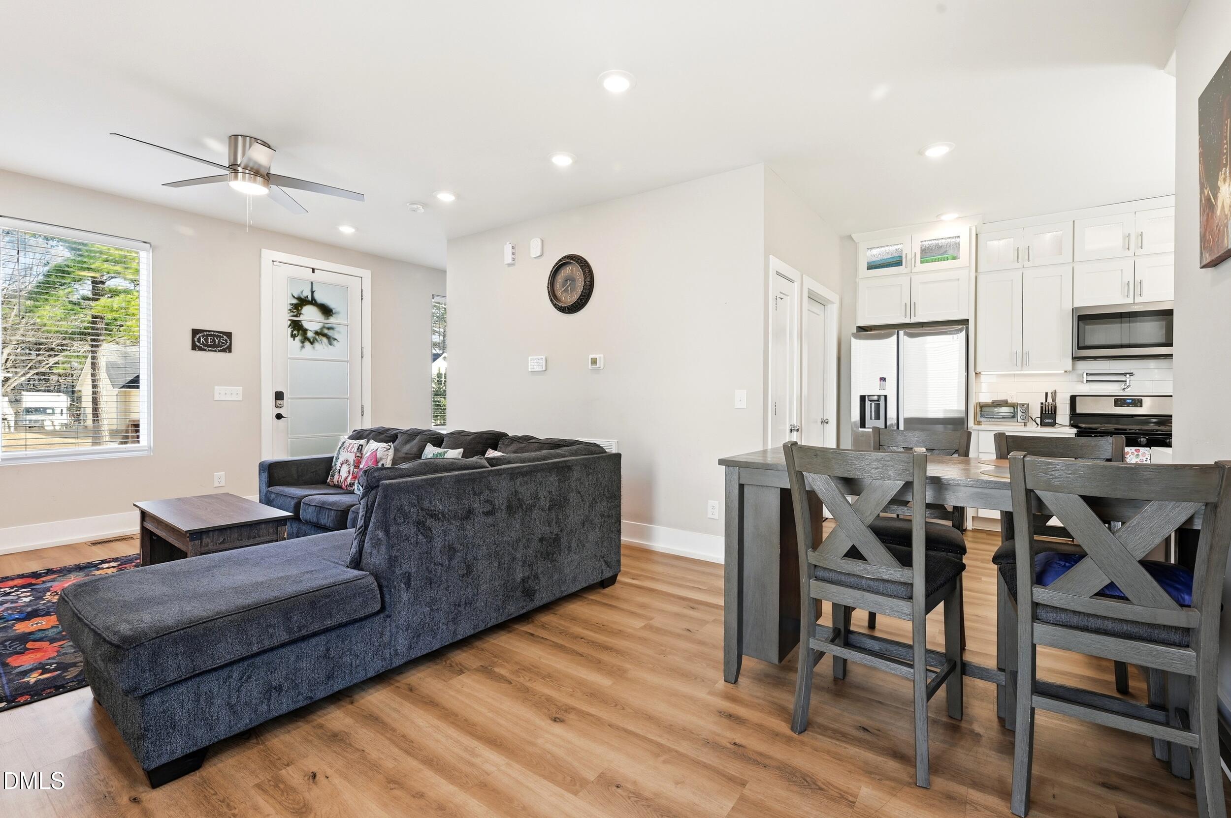 3138 Rowena Avenue Durham, NC 27703 - Photo 7 of 31 a living room with furniture kitchen and a wooden floor