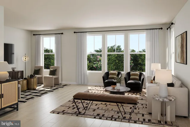 a living room with furniture and large windows