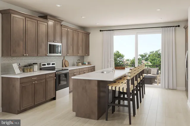 a kitchen with a table chairs sink and cabinets