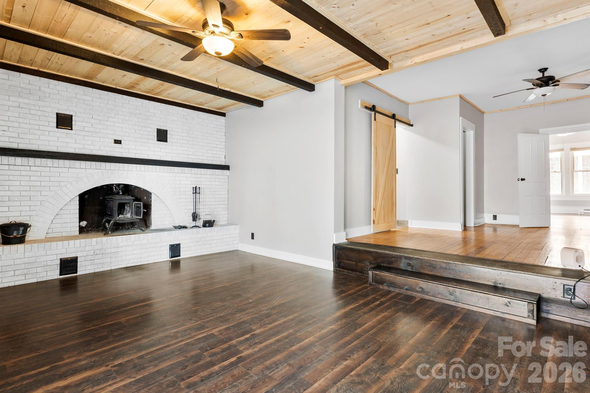 42 Old Patton Hill Road Swannanoa, NC 28778 - Photo 12 of 33 a living room with kitchen island a table and a stove
