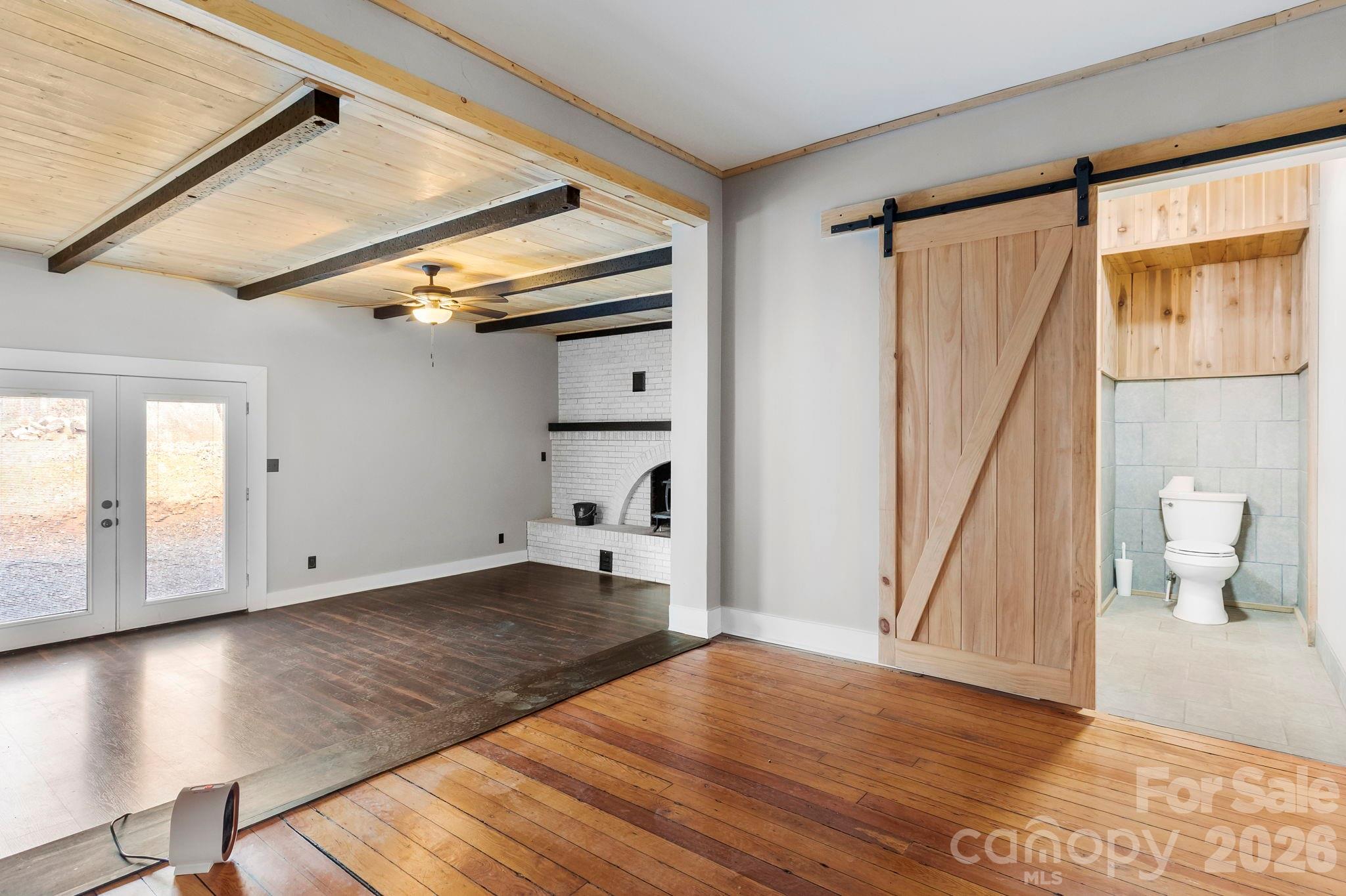 42 Old Patton Hill Road Swannanoa, NC 28778 - Photo 14 of 33 a view of empty room with wooden floor and fan