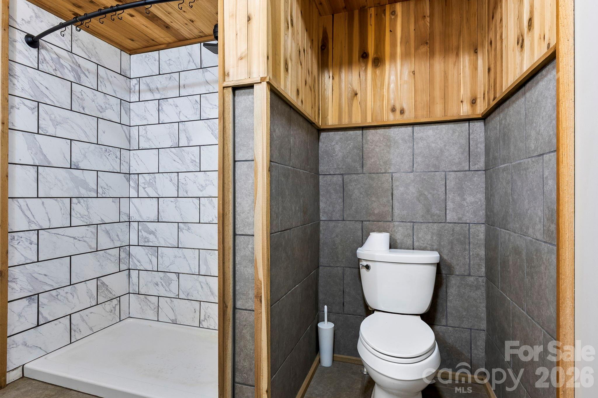 42 Old Patton Hill Road Swannanoa, NC 28778 - Photo 15 of 33 a bathroom with a toilet and a shower
