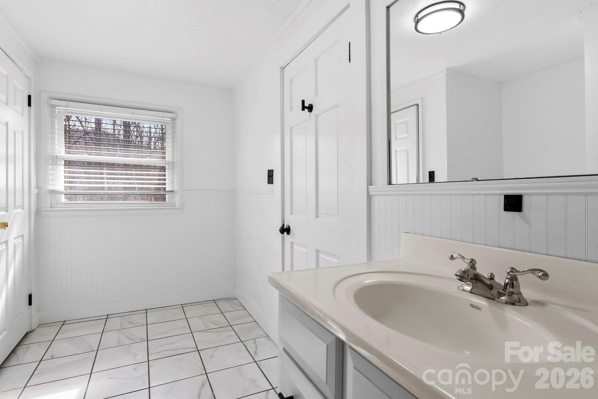 42 Old Patton Hill Road Swannanoa, NC 28778 - Photo 23 of 33 a bathroom with a sink a vanity and a mirror