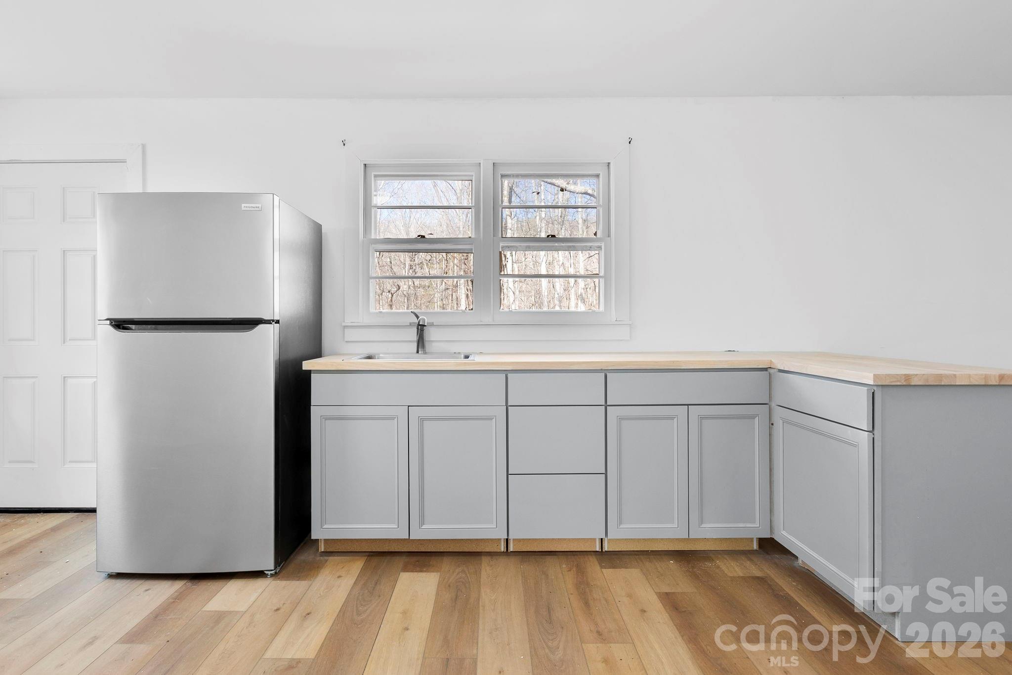 42 Old Patton Hill Road Swannanoa, NC 28778 - Photo 27 of 33 a view of a kitchen with white cabinets and refrigerator