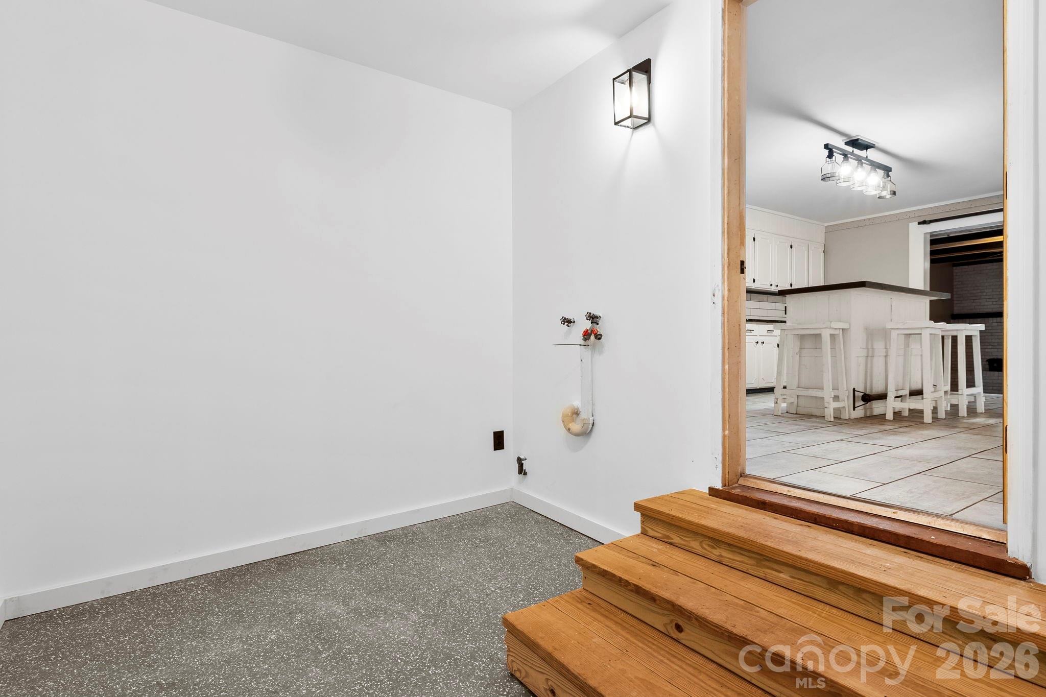 42 Old Patton Hill Road Swannanoa, NC 28778 - Photo 30 of 33 a view of a hallway with wooden floor and a kitchen view