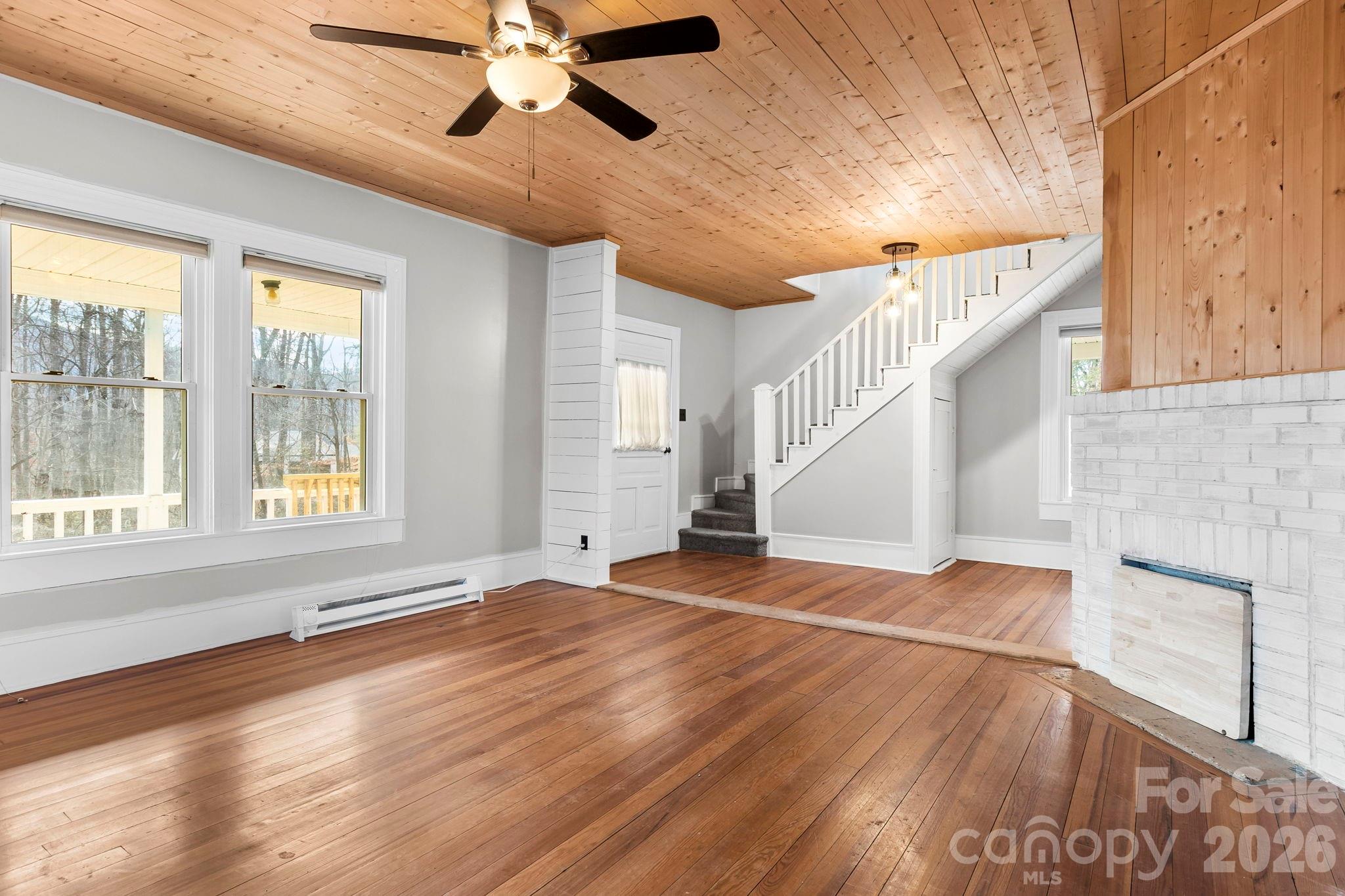 42 Old Patton Hill Road Swannanoa, NC 28778 - Photo 5 of 33 a view of empty room with wooden floor and fan