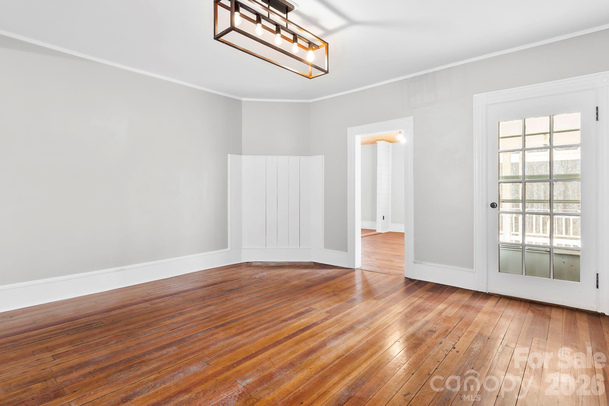 42 Old Patton Hill Road Swannanoa, NC 28778 - Photo 7 of 33 an empty room with wooden floor and windows