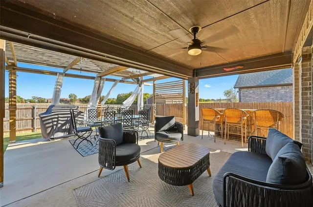 a view of a house with a small yard and a large tree