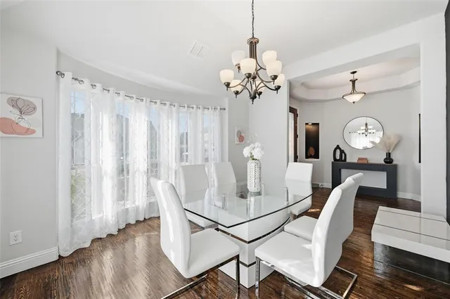 a view of a dining room with furniture and a chandelier