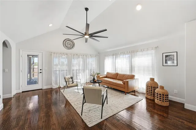 a living room with furniture and kitchen view