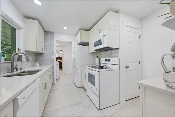 a kitchen with a sink and refrigerator