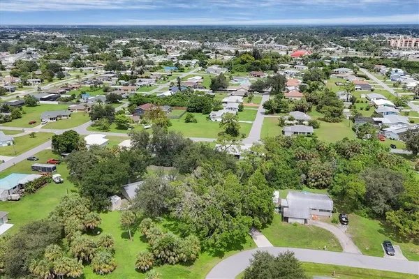 an aerial view of a house with a yard