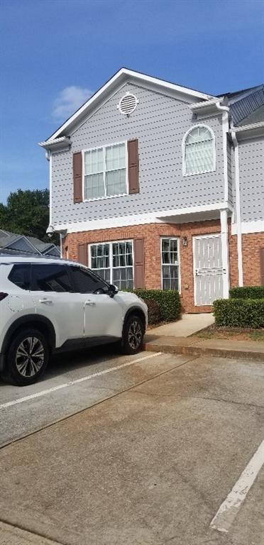 a view of a car parked in front of a house