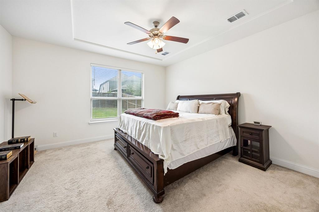 11732 Wulstone Road Fort Worth, TX 76052 - Photo 9 of 34 Light-filled room featuring a tray ceiling, ceiling fan, and window with blinds