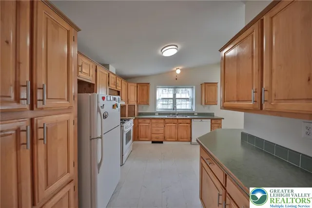 a kitchen with refrigerator and cabinets