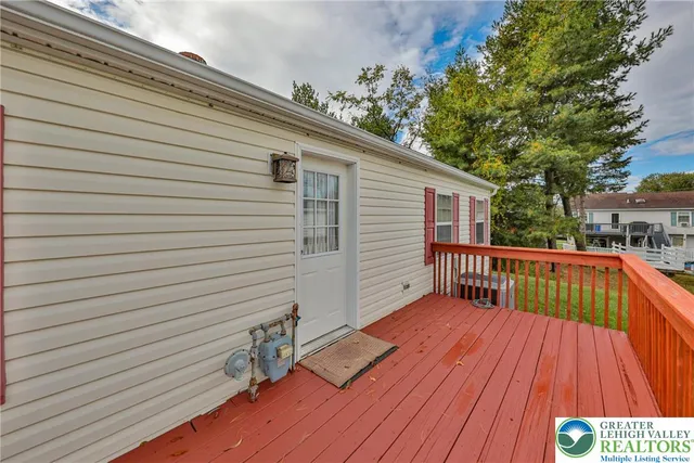 a view of balcony with wooden floor and fence