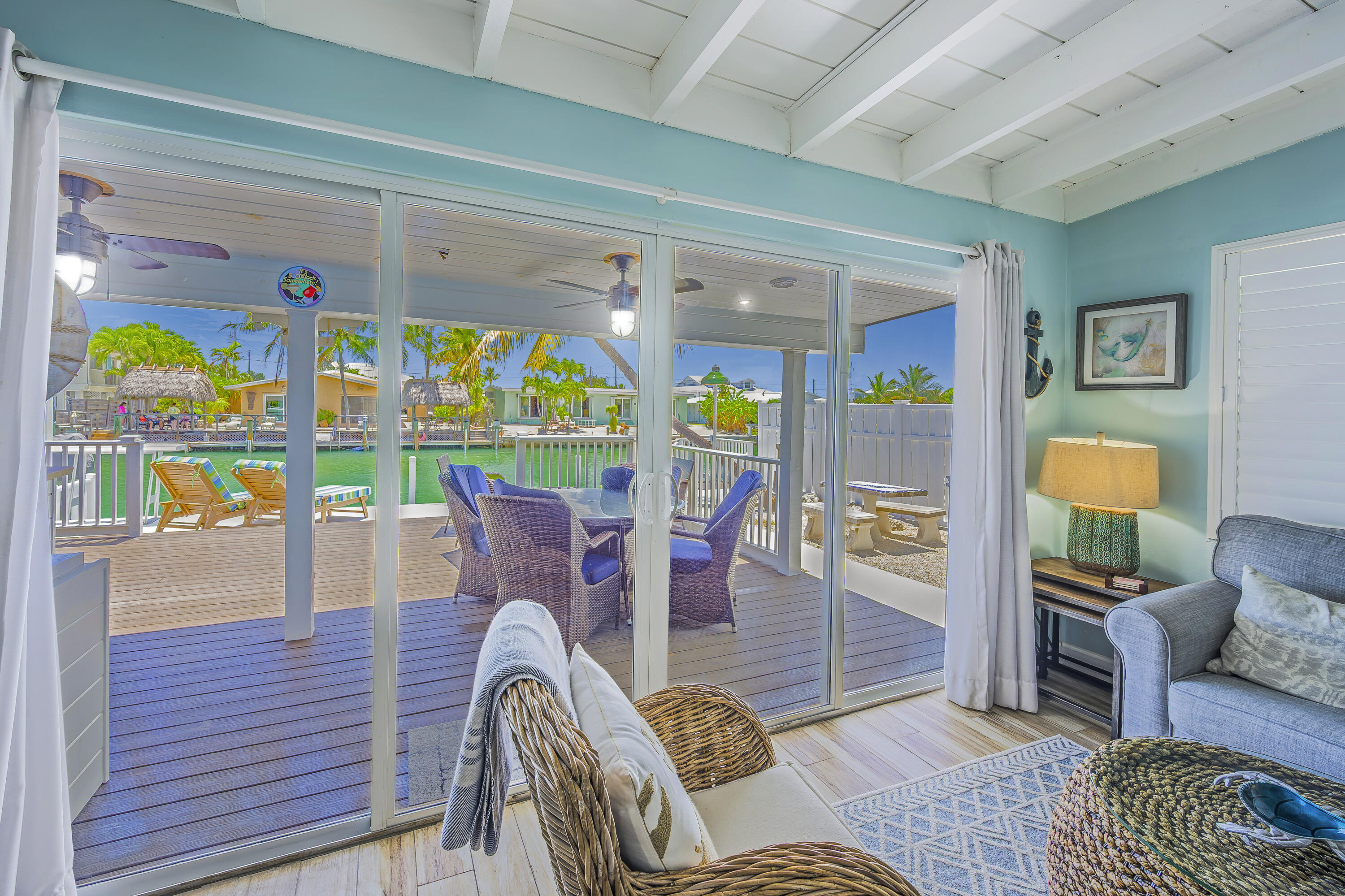 340 10th Street Key Colony Beach, FL 33051 - Photo 11 of 24 a outdoor living space with furniture and a floor to ceiling window