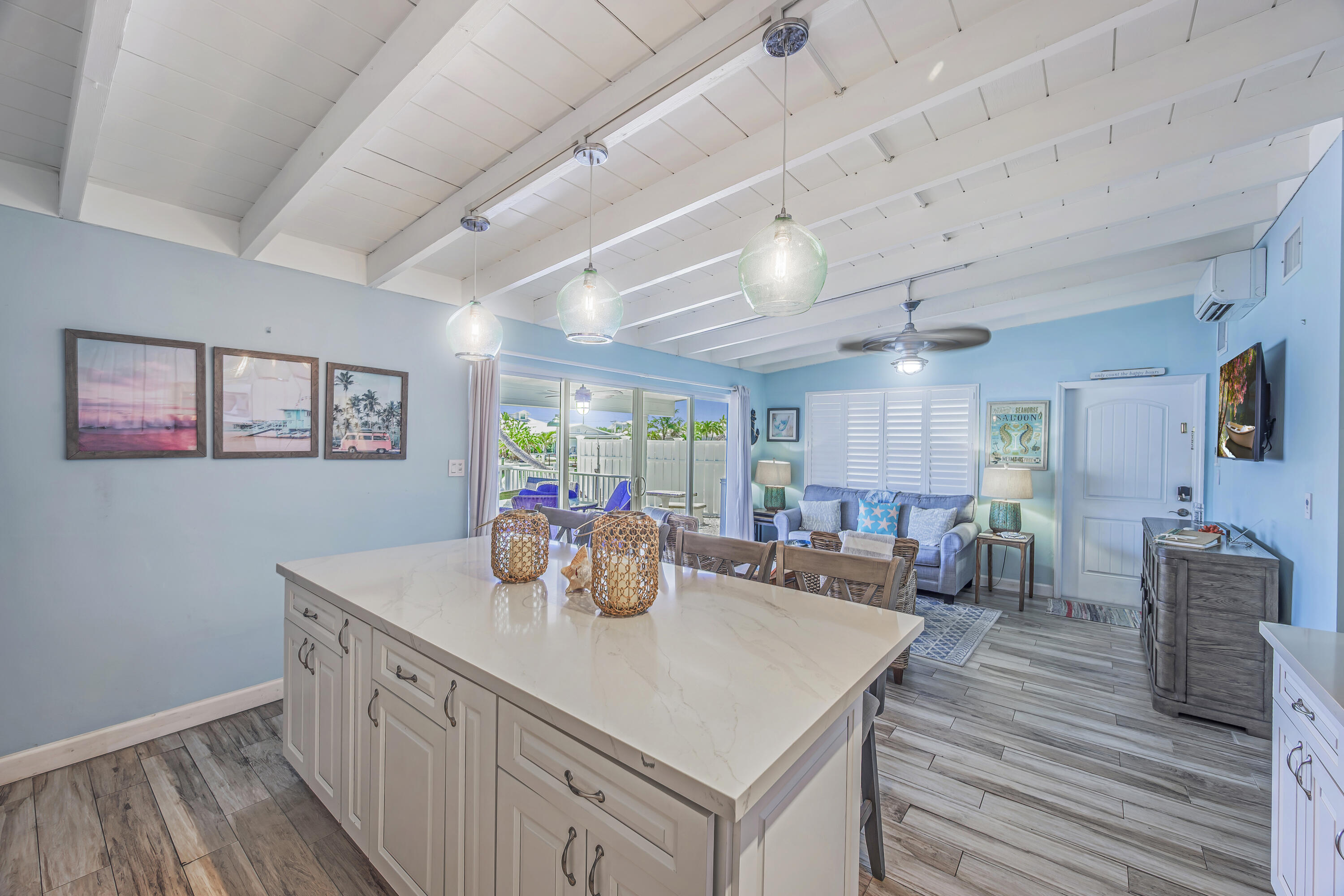 340 10th Street Key Colony Beach, FL 33051 - Photo 13 of 24 a view of a dining room with furniture a chandelier and wooden floor
