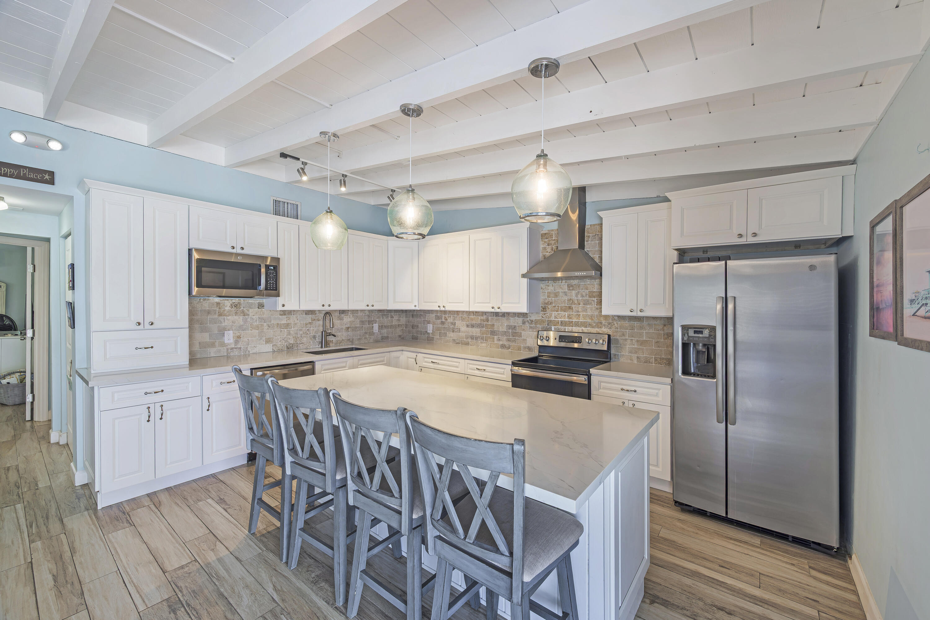 340 10th Street Key Colony Beach, FL 33051 - Photo 14 of 24 a kitchen with stainless steel appliances a refrigerator a stove a table and chairs
