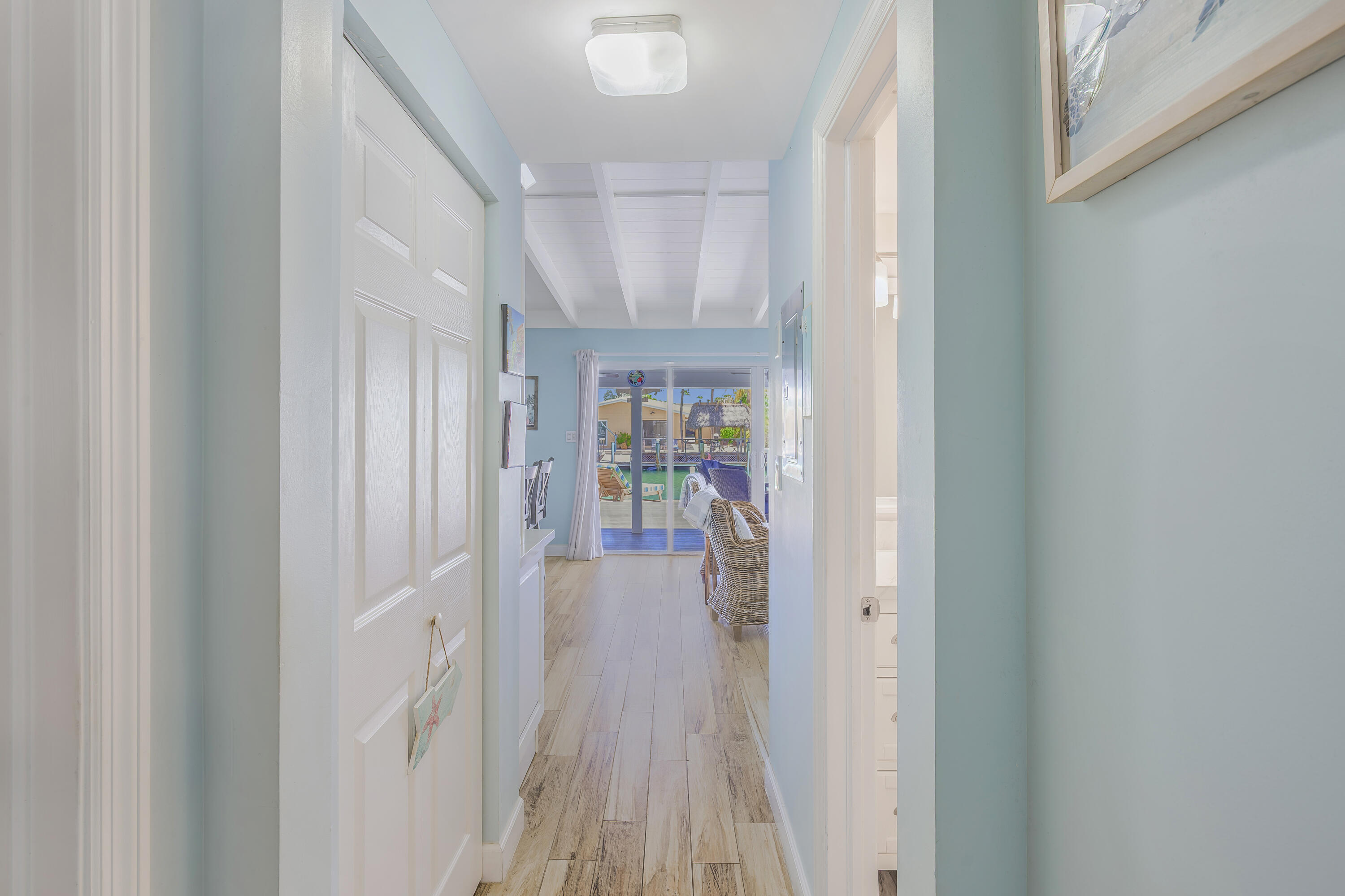 340 10th Street Key Colony Beach, FL 33051 - Photo 17 of 24 a view of a hallway with wooden floor and a livingroom view
