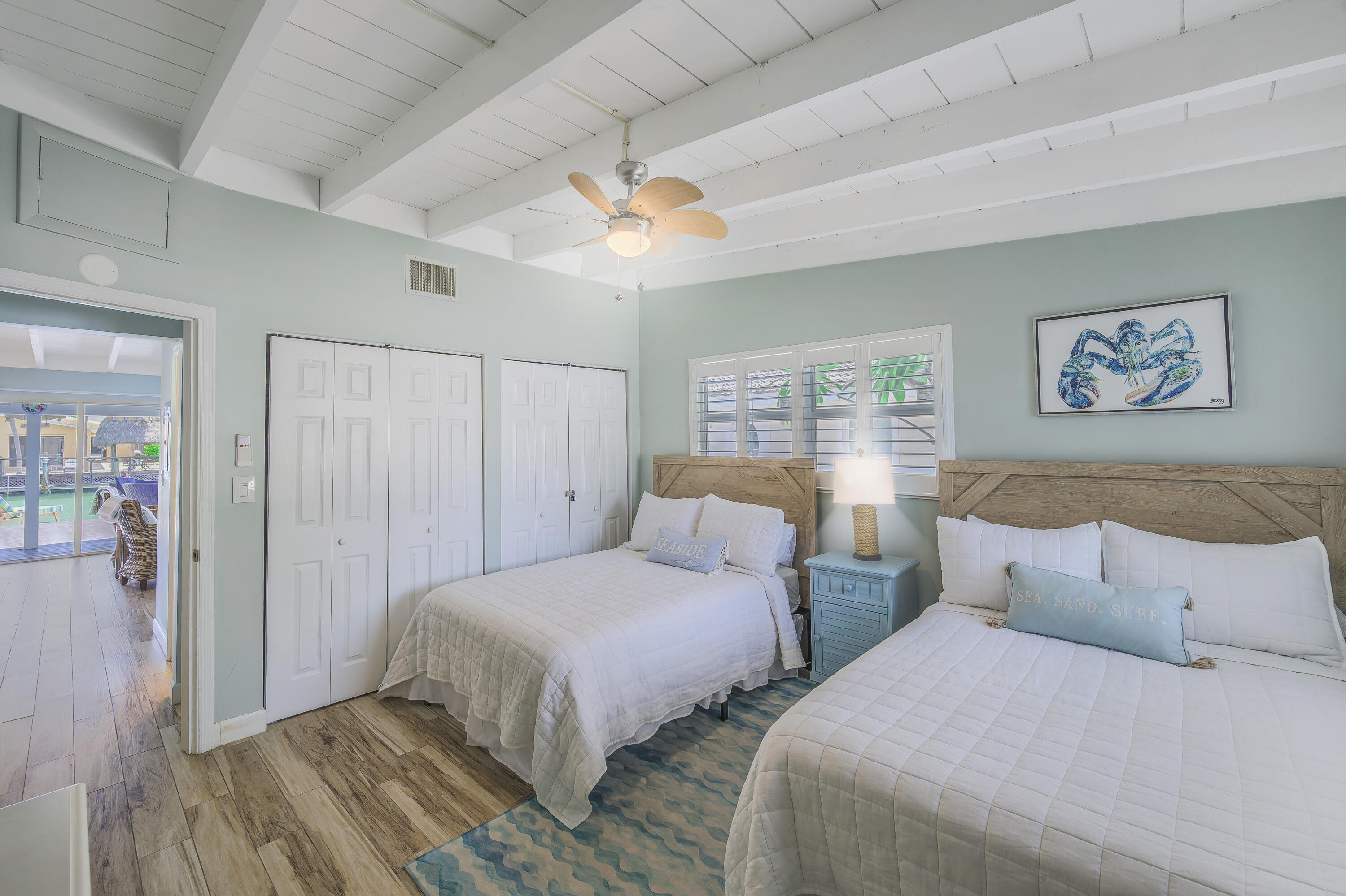 340 10th Street Key Colony Beach, FL 33051 - Photo 19 of 24 a bedroom with two beds and a painting on the wall