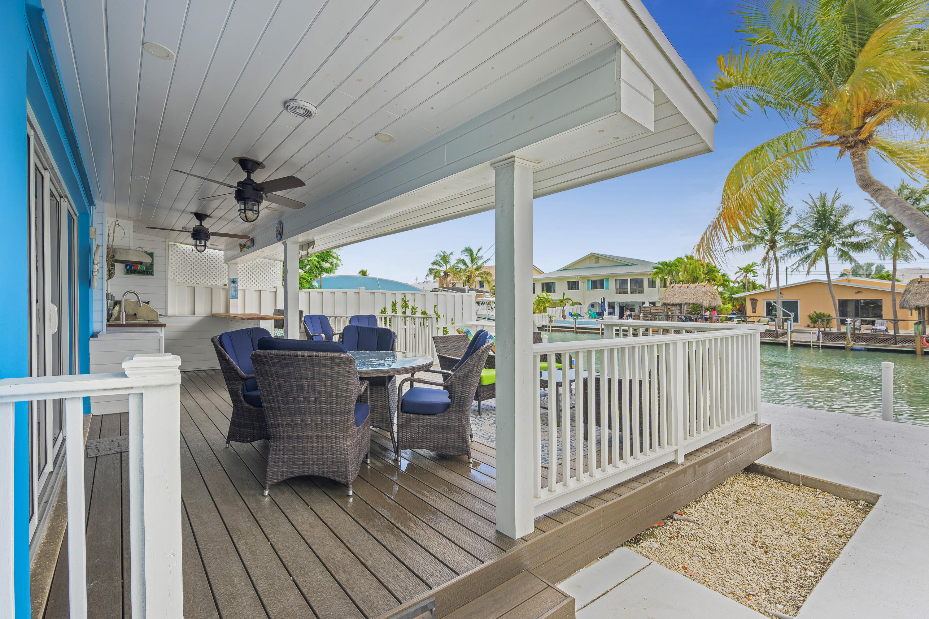 340 10th Street Key Colony Beach, FL 33051 - Photo 4 of 24 a view of a chairs and table in patio with wooden floor