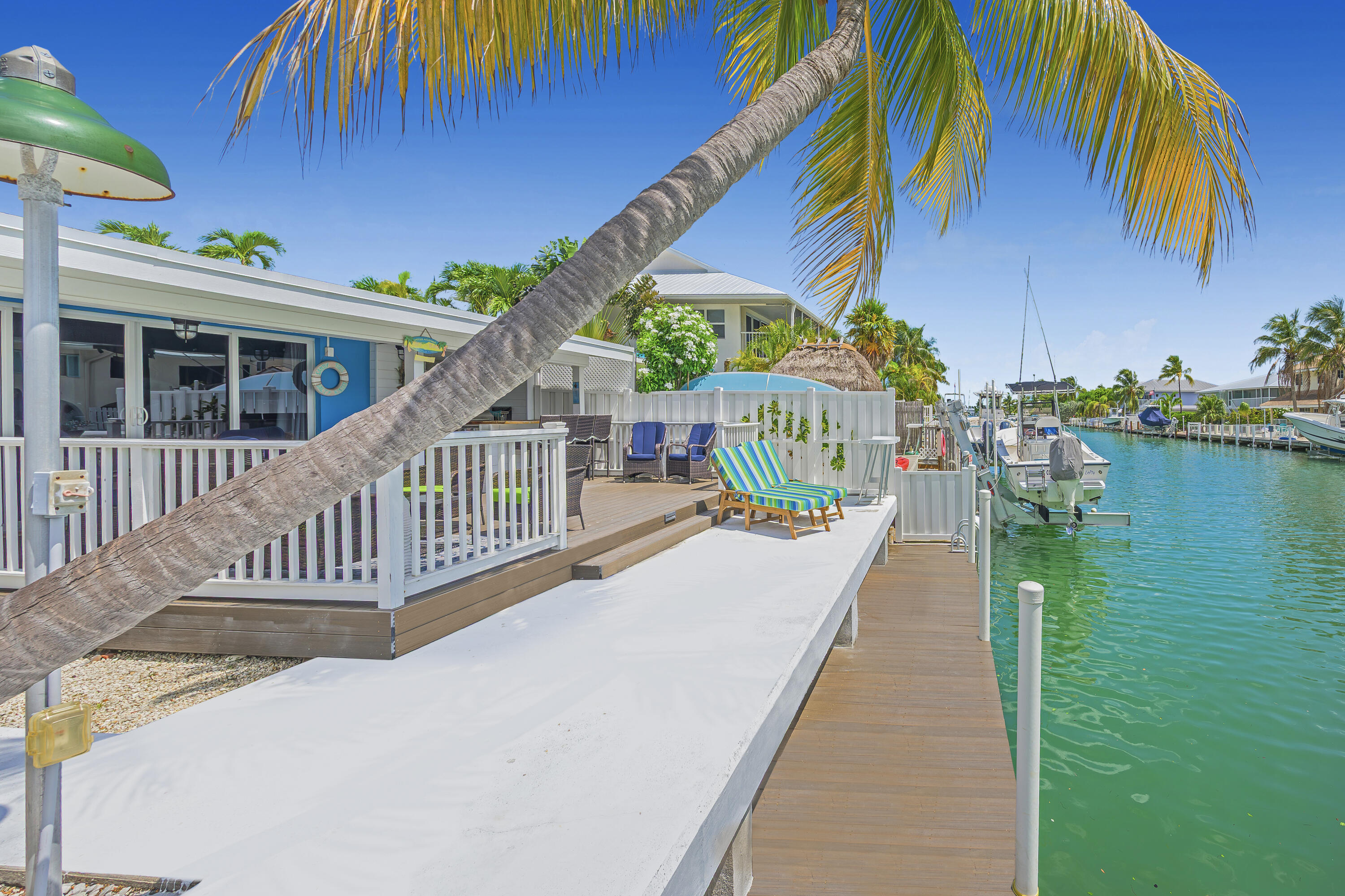 340 10th Street Key Colony Beach, FL 33051 - Photo 5 of 24 a view of a house with a swimming pool and a patio