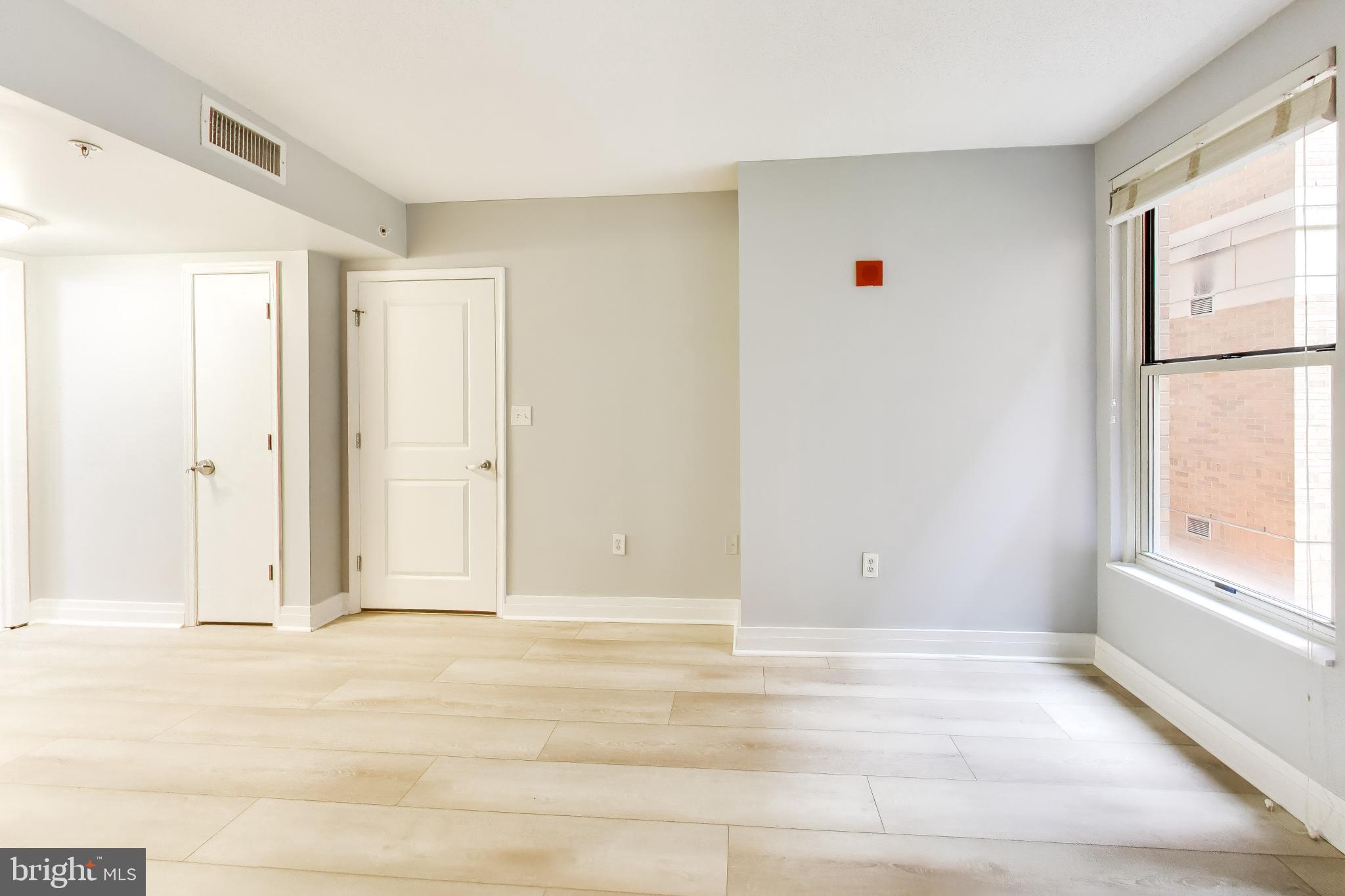 915 E Street Northwest, Unit 414 Washington, DC 20004 - Photo 14 of 35 an empty room with windows