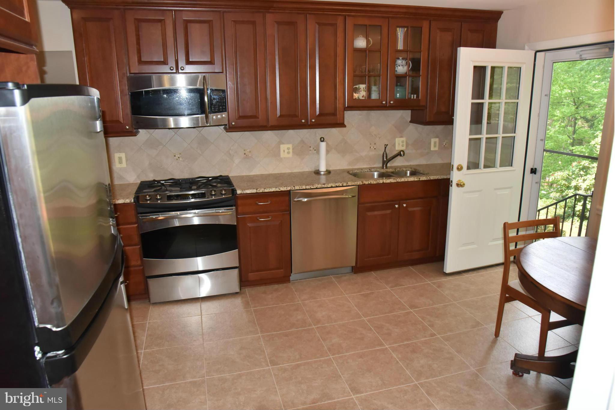 3821 King Arthur Road Annandale, VA 22003 - Photo 4 of 30 a kitchen with stainless steel appliances granite countertop a stove a sink and a refrigerator