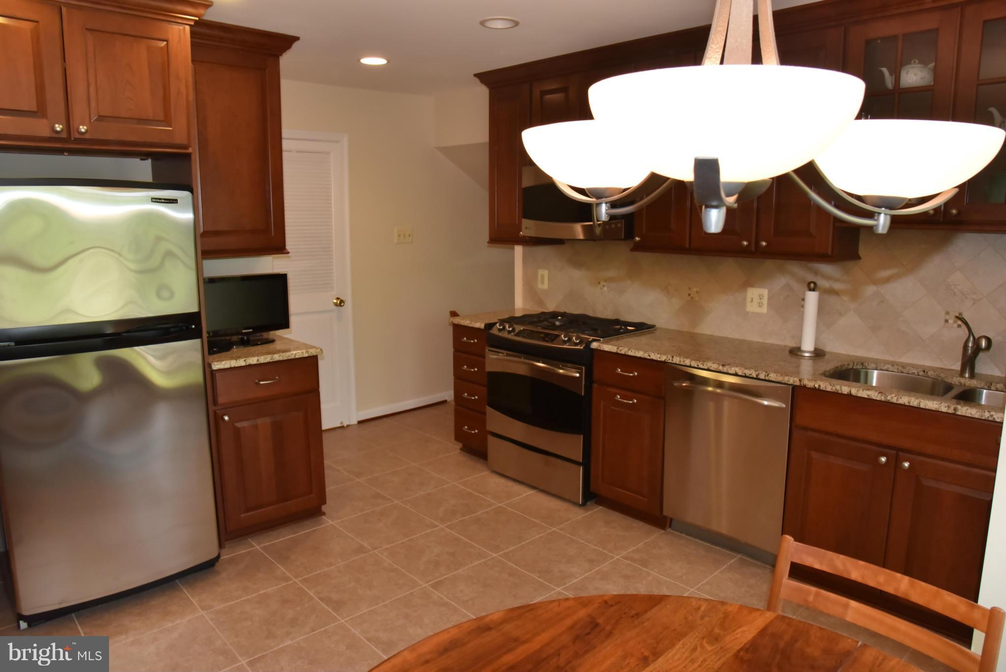 3821 King Arthur Road Annandale, VA 22003 - Photo 5 of 30 a kitchen with stainless steel appliances granite countertop a stove and a microwave