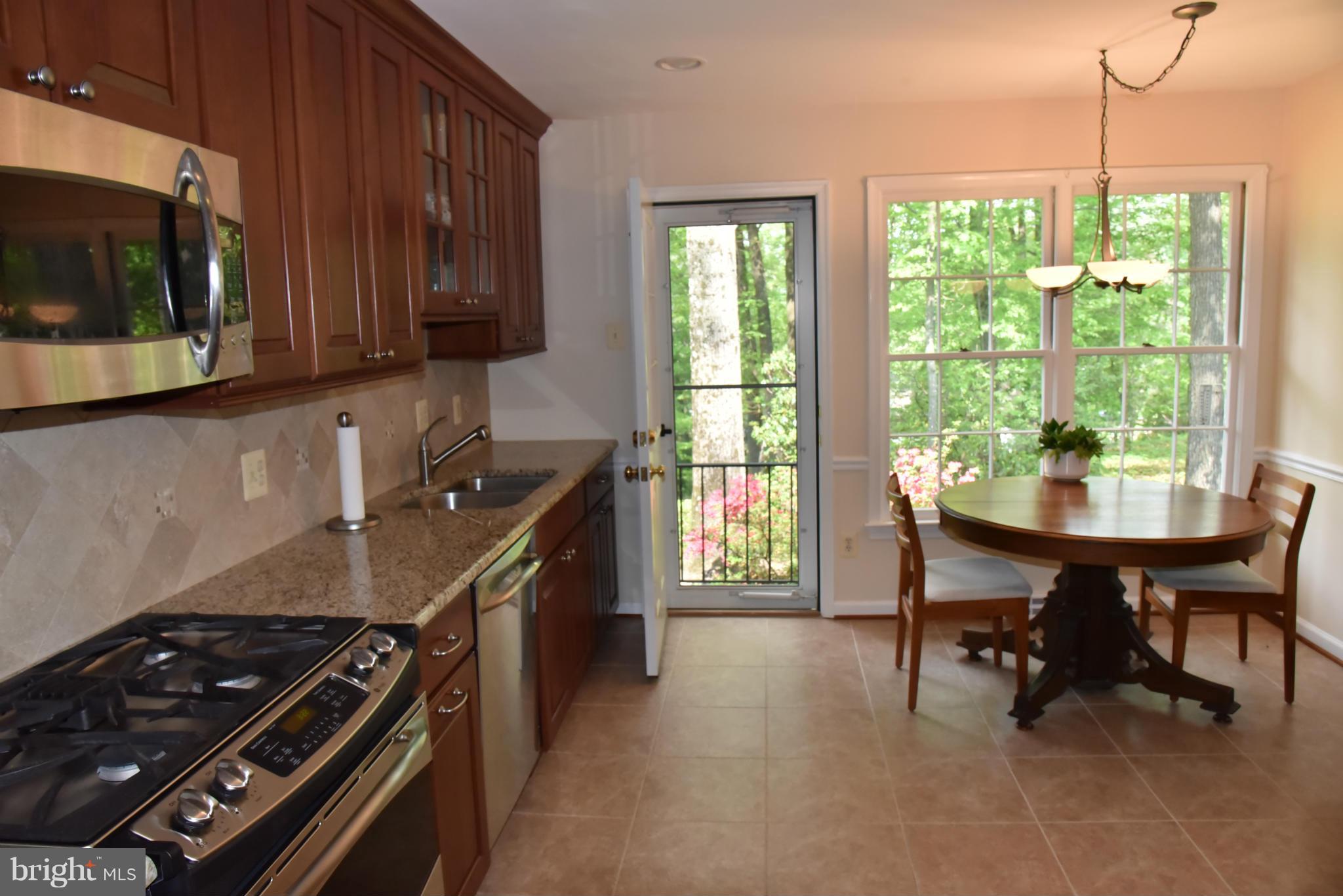 3821 King Arthur Road Annandale, VA 22003 - Photo 6 of 30 a kitchen with a stove a sink and a microwave