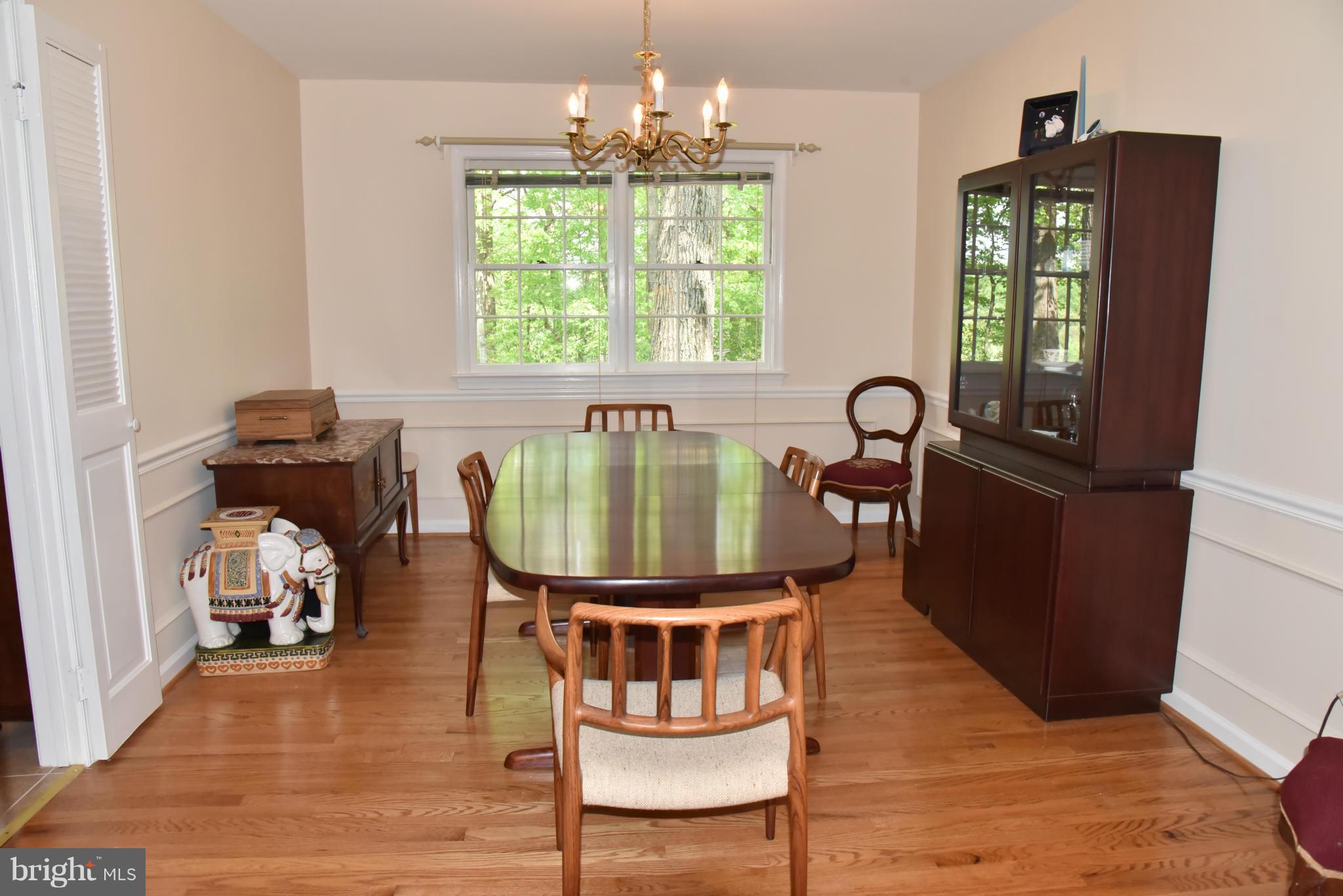 3821 King Arthur Road Annandale, VA 22003 - Photo 7 of 30 a dining room with furniture a chandelier and wooden floor