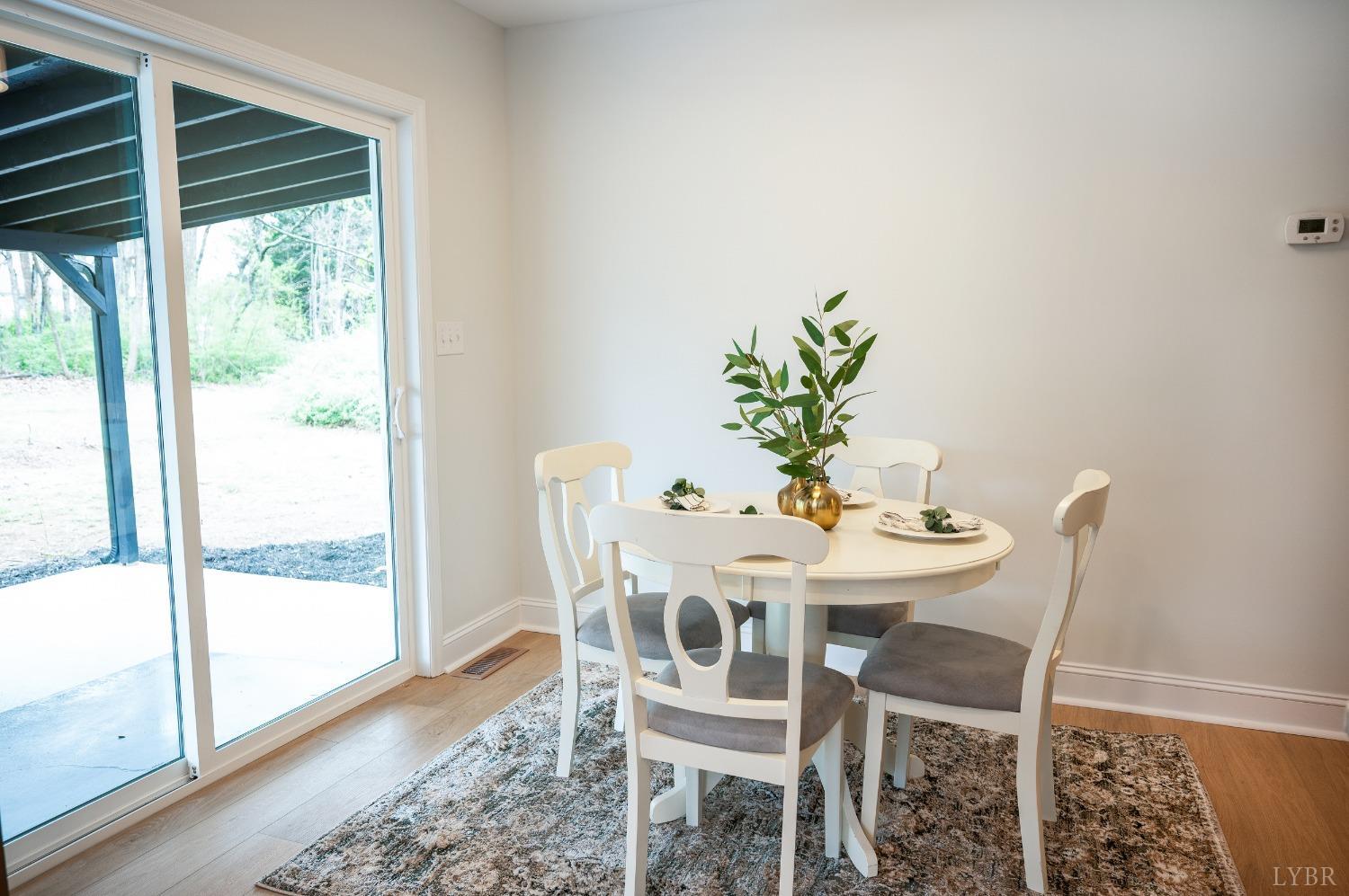 1761 Old Farm Road Lynchburg, VA 24503 - Photo 16 of 60 a dining room with furniture potted plants and wooden floor