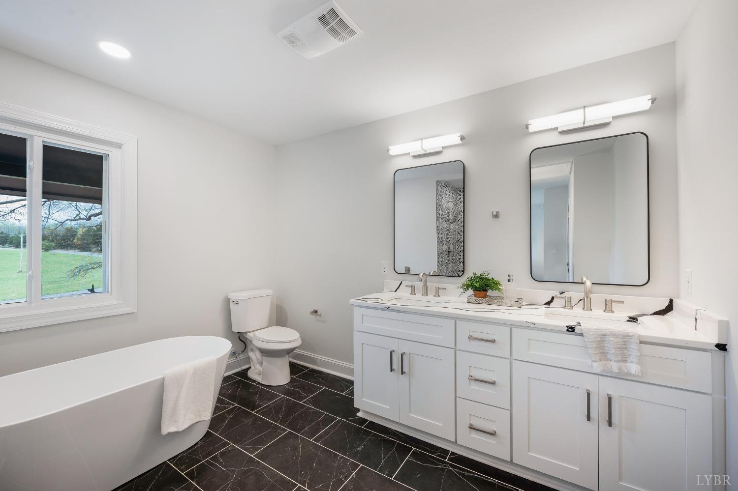 1761 Old Farm Road Lynchburg, VA 24503 - Photo 26 of 60 a spacious bathroom with a double vanity sink toilet mirror and bathtub