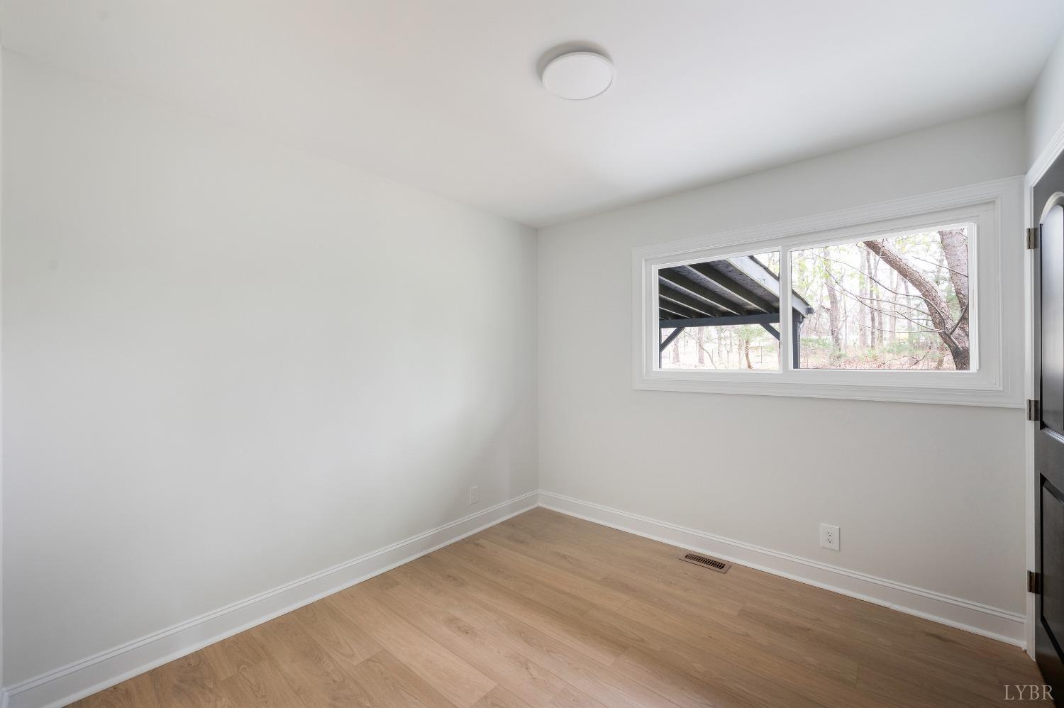 1761 Old Farm Road Lynchburg, VA 24503 - Photo 33 of 60 an empty room with wooden floor and windows