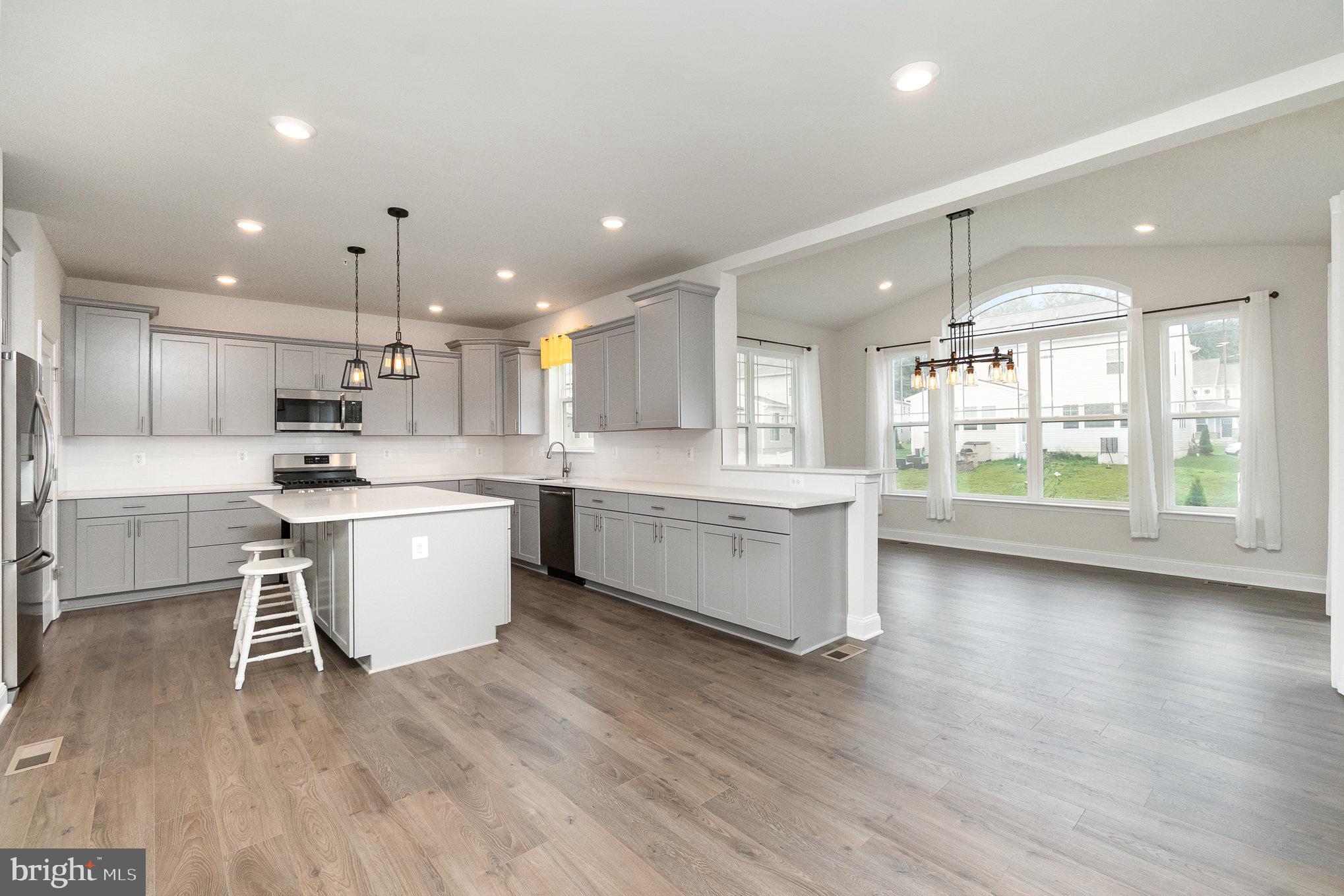 1126 Up And Over Lane Aberdeen, MD 21001 - Photo 14 of 46 a kitchen with a white wooden cabinets and white appliances