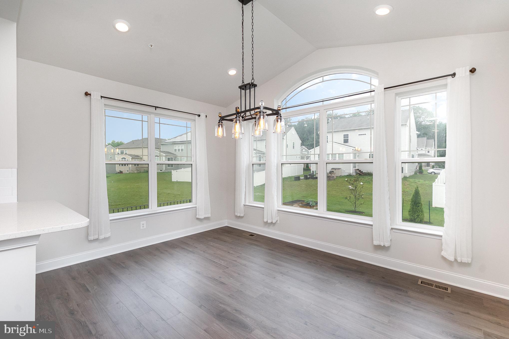 1126 Up And Over Lane Aberdeen, MD 21001 - Photo 16 of 46 a view of an empty room with a window and wooden floor