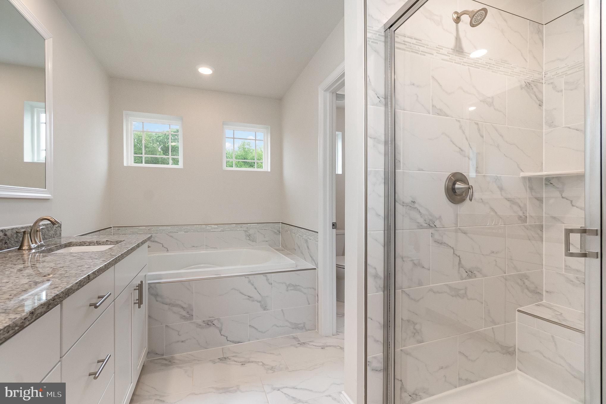 1126 Up And Over Lane Aberdeen, MD 21001 - Photo 28 of 46 a bathroom with a granite countertop sink a shower and a bathtub