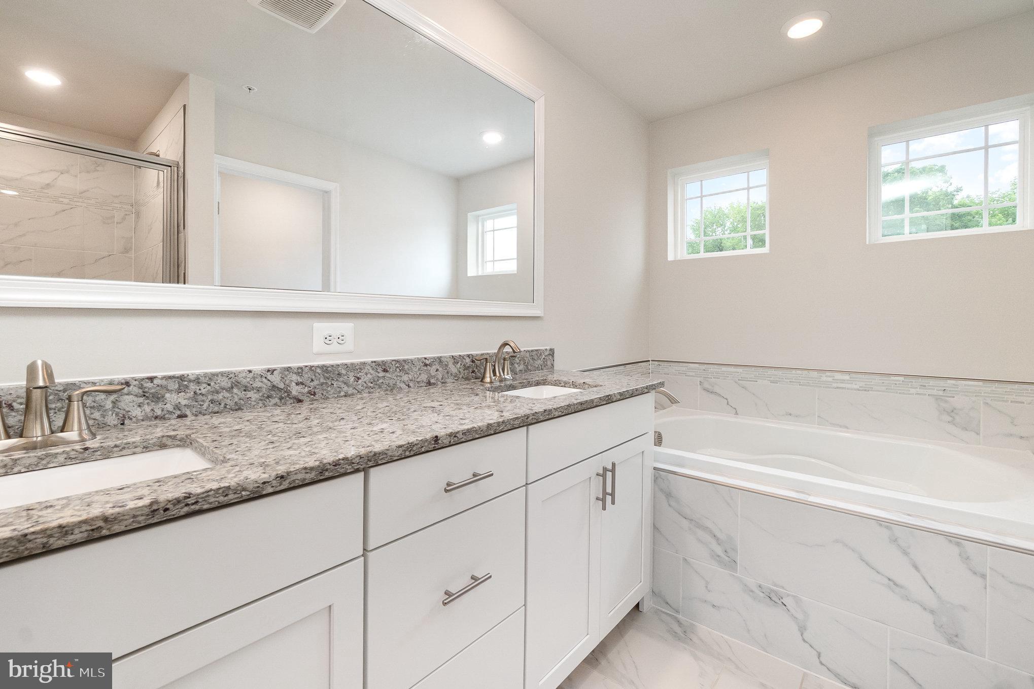 1126 Up And Over Lane Aberdeen, MD 21001 - Photo 29 of 46 a bathroom with a granite countertop bathtub sink and mirror