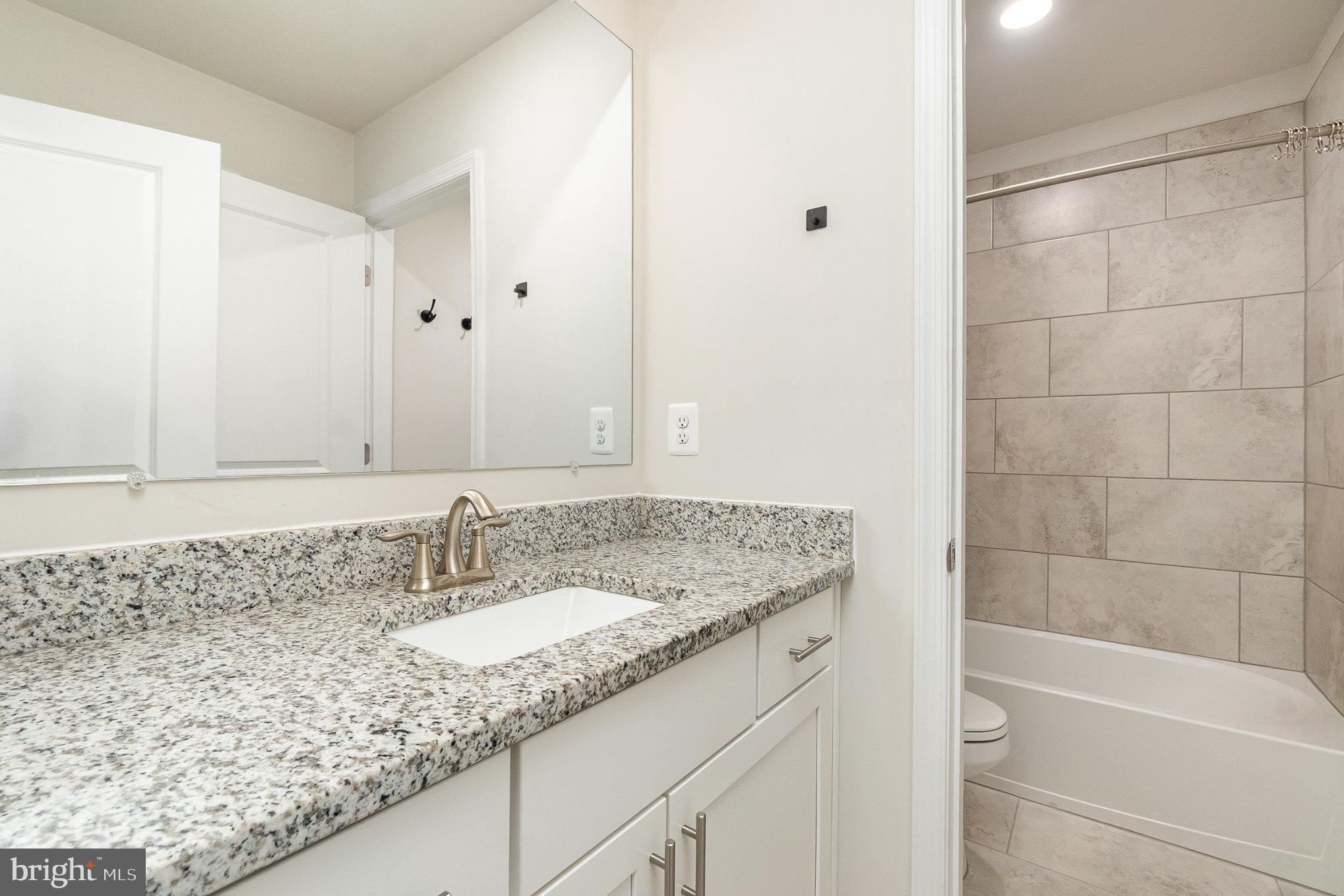 1126 Up And Over Lane Aberdeen, MD 21001 - Photo 35 of 46 a bathroom with a granite countertop sink and a mirror