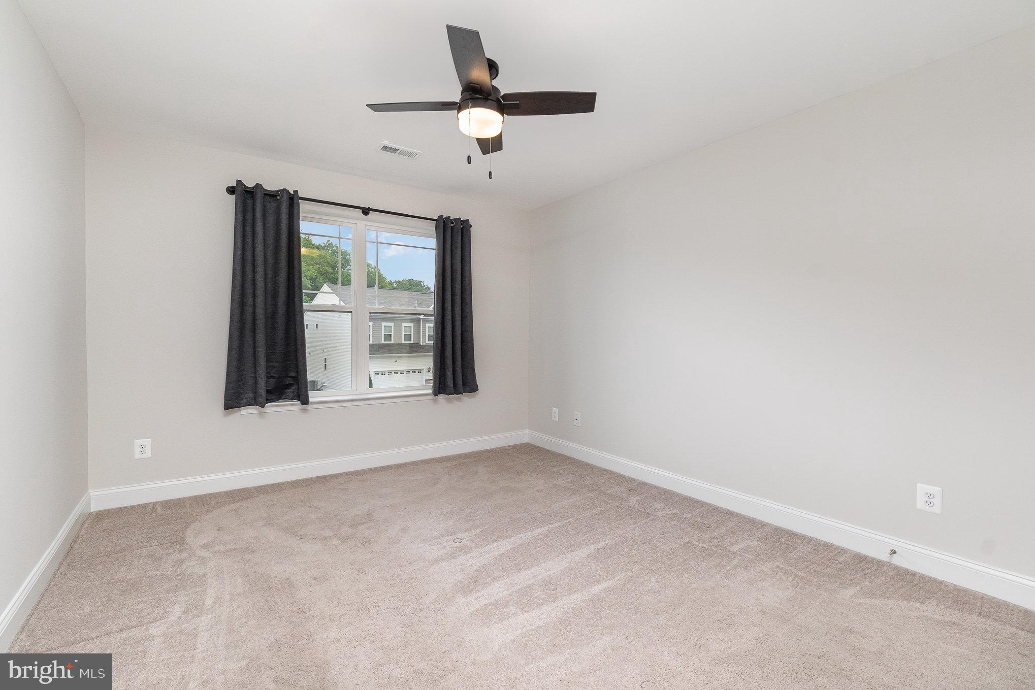1126 Up And Over Lane Aberdeen, MD 21001 - Photo 40 of 46 an empty room with a ceiling fan and window