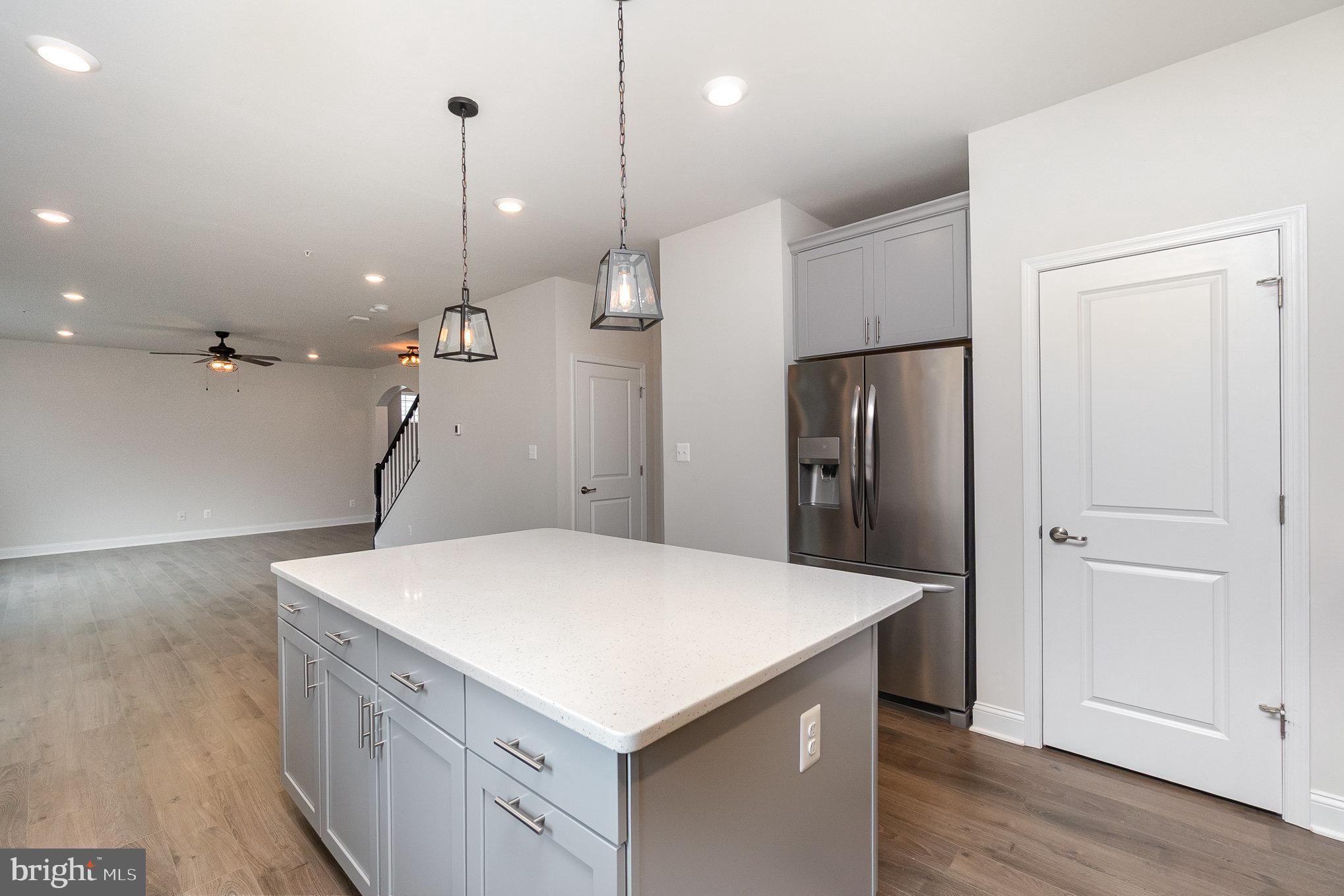 1126 Up And Over Lane Aberdeen, MD 21001 - Photo 9 of 46 a kitchen with a refrigerator a sink and wooden floor