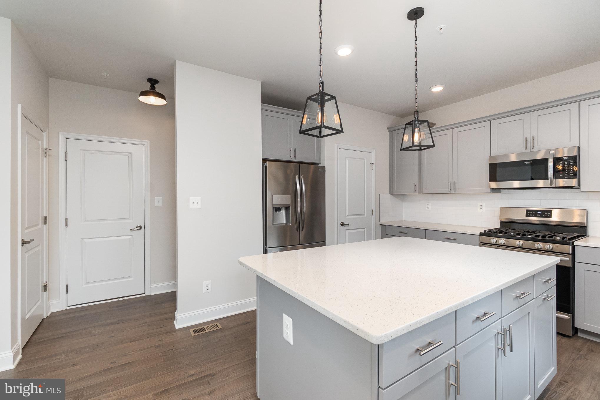 1126 Up And Over Lane Aberdeen, MD 21001 - Photo 10 of 46 a kitchen with kitchen island a sink stainless steel appliances and wooden floor
