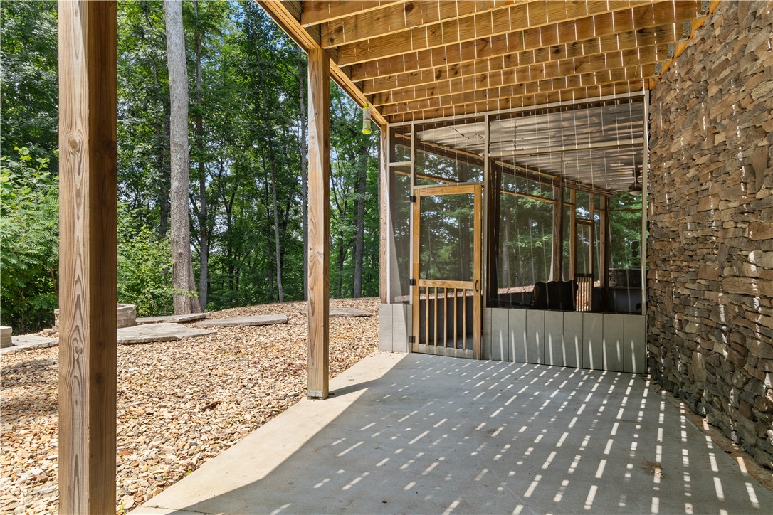 332 Two Rivers Drive Westminster, SC 29693 - Photo 10 of 50 A screened porch and patio provides a secluded outdoor living space.