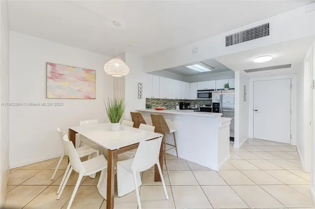 a kitchen with cabinets and chairs