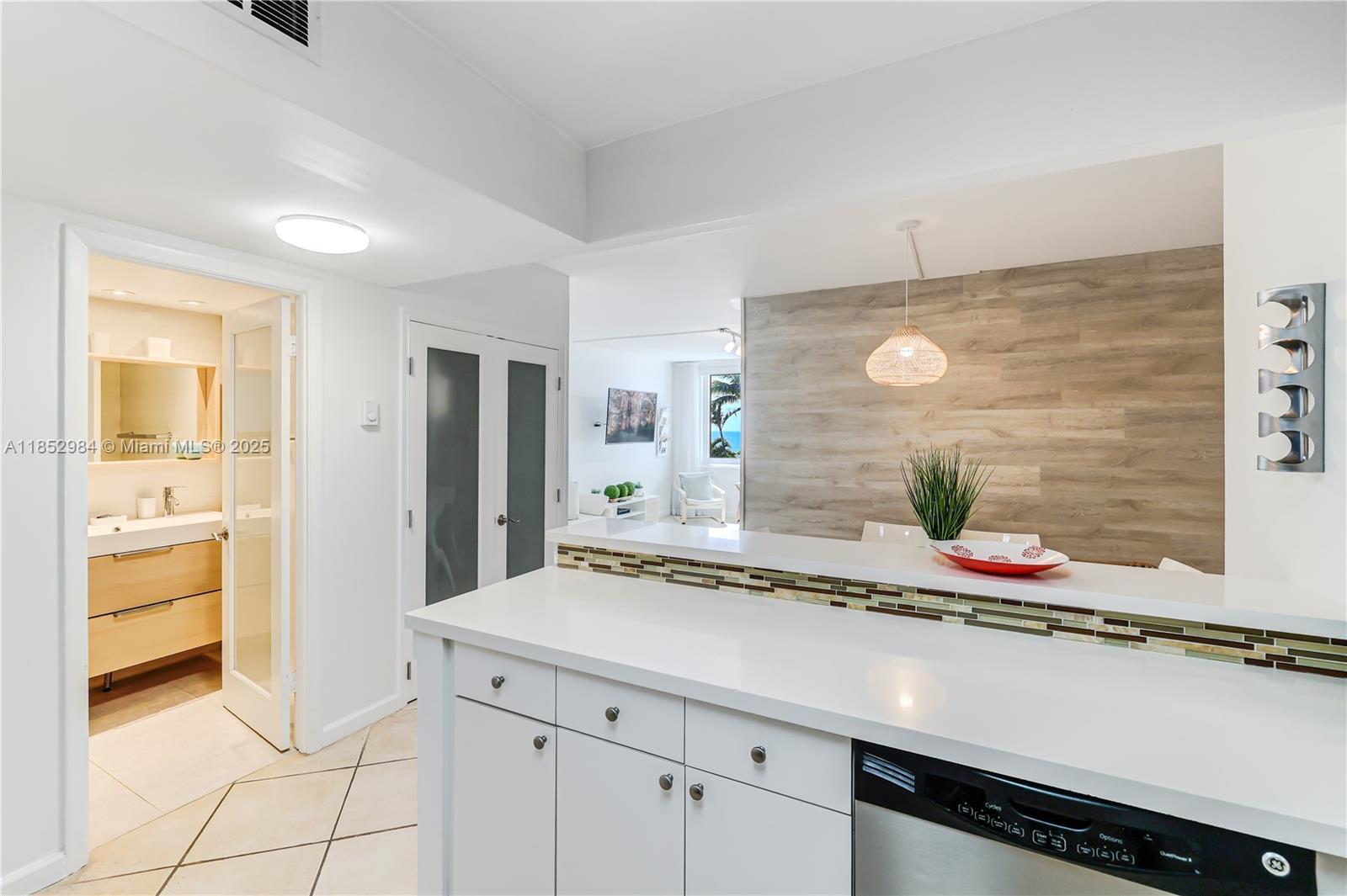 2301 Collins Avenue, Unit 523 Miami Beach, FL 33139 - Photo 14 of 49 a bathroom with a granite countertop sink and a mirror