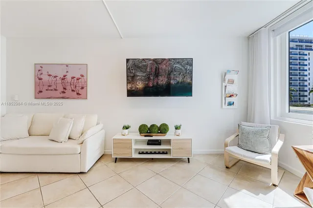 a living room with furniture and a painting