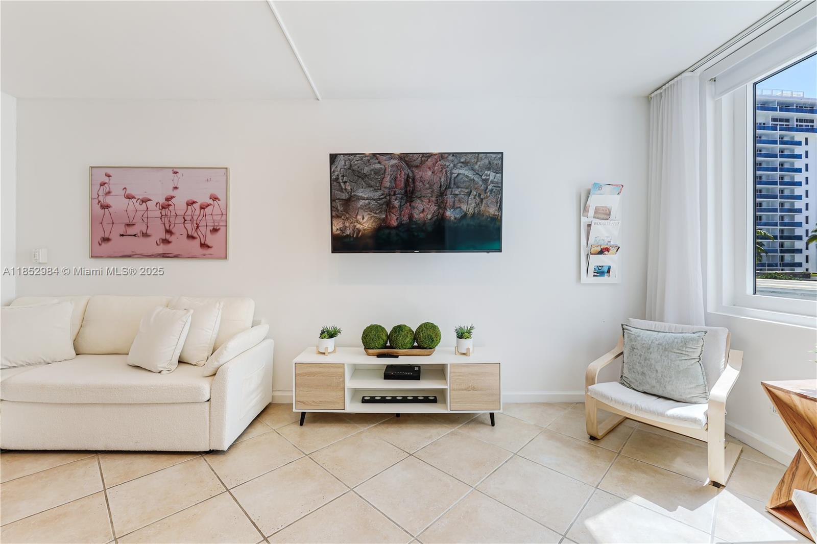 2301 Collins Avenue, Unit 523 Miami Beach, FL 33139 - Photo 17 of 49 a living room with furniture and a painting