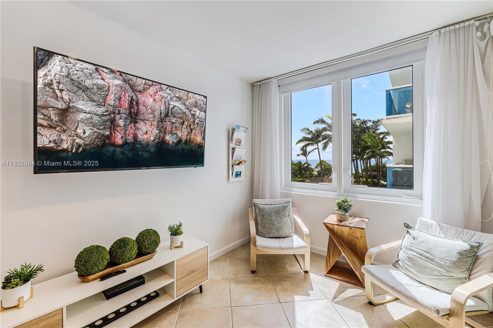 2301 Collins Avenue, Unit 523 Miami Beach, FL 33139 - Photo 18 of 49 a living room with furniture and a painting on the wall